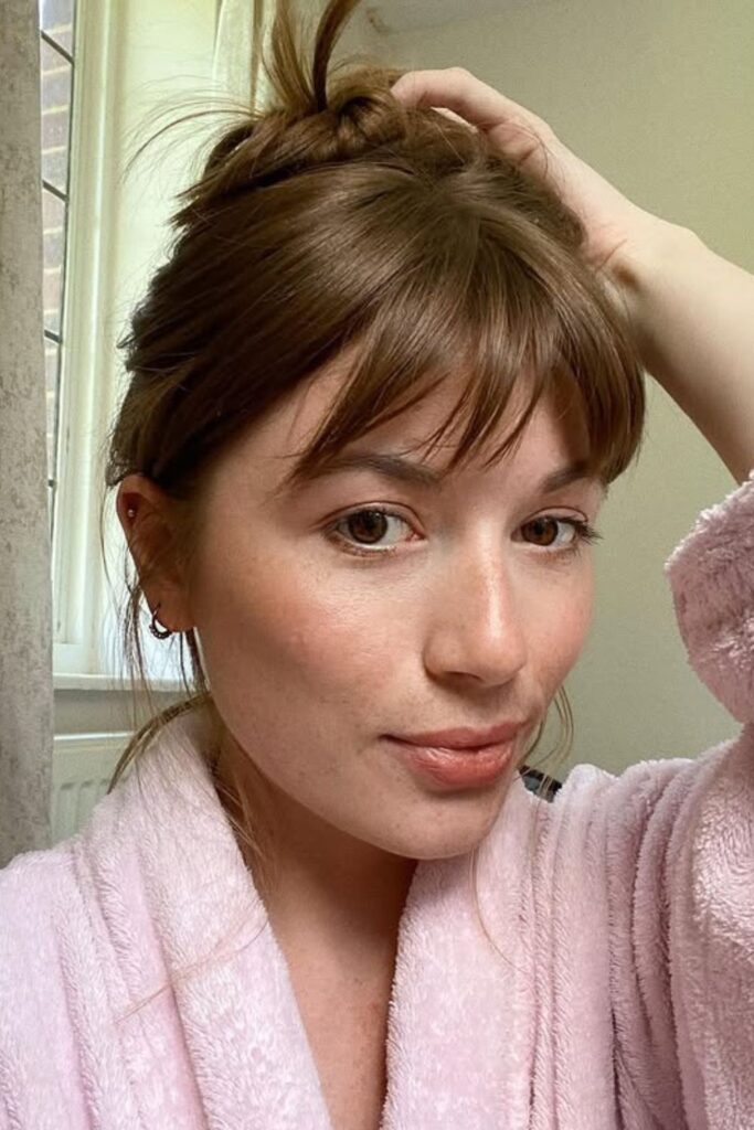 Messy Bun with Bangs.